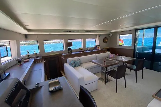  Yacht Photos Pics Luxurious interior of 2019 Lagoon 630 Motor Yacht with ocean view through large windows.