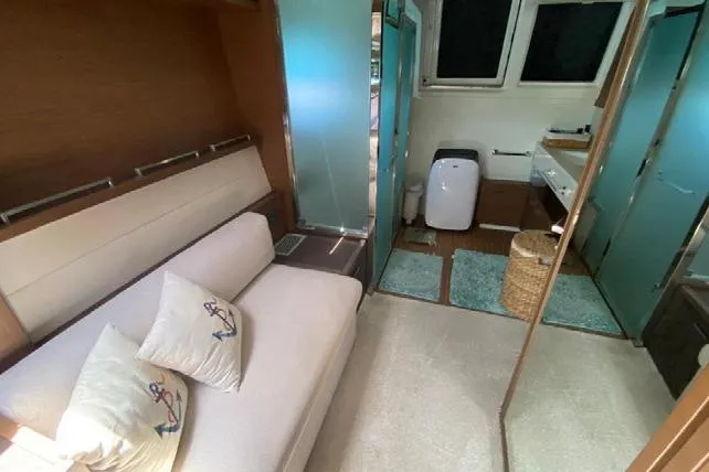  Yacht Photos Pics Luxurious interior of 2019 Lagoon 630 Motor Yacht with cozy seating and modern bathroom.