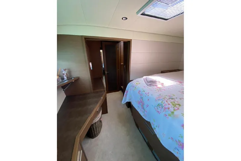  Yacht Photos Pics Luxurious bedroom interior of 2019 Lagoon 630 Motor Yacht with floral bedding and skylight.