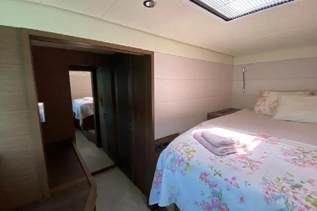  Yacht Photos Pics Luxurious bedroom interior of 2019 Lagoon 630 Motor Yacht with floral bedding.