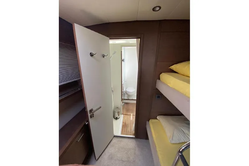  Yacht Photos Pics Interior of 2019 Lagoon 630 Motor Yacht with bunk beds and bathroom.