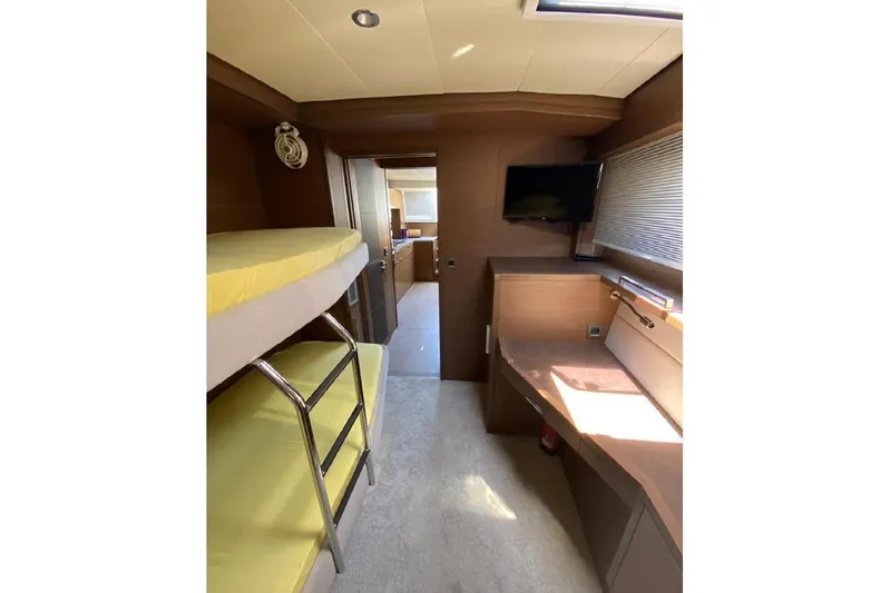  Yacht Photos Pics Interior of 2019 Lagoon 630 Motor Yacht with bunk beds and desk area.