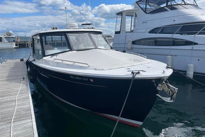 O-m-g Yacht Photos Pics 2023 MJM 3 boat docked at marina, clear sky, calm water.