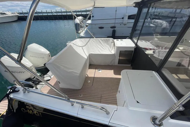 O-m-g Yacht Photos Pics 2023 MJM 3 boat deck with Mercury engines, covered seating, and sleek design.