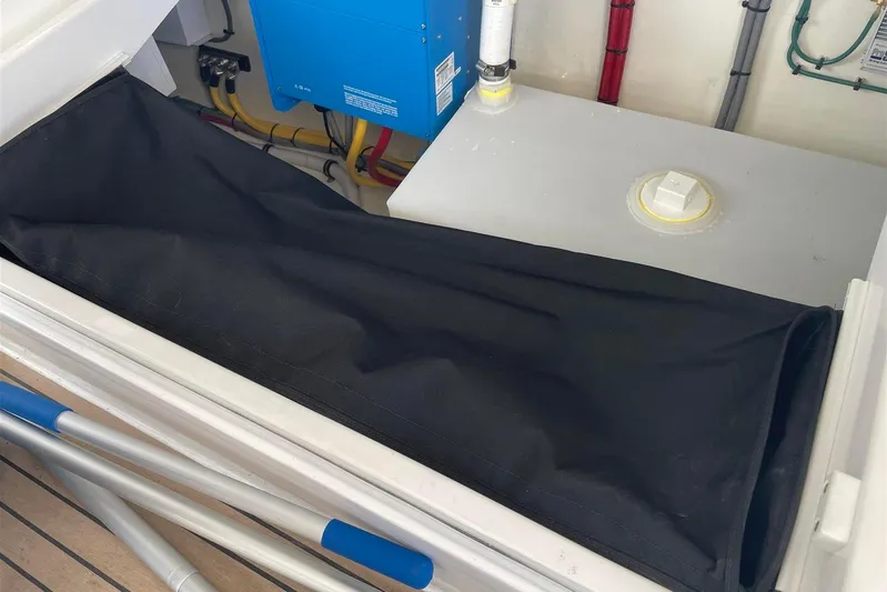 O-m-g Yacht Photos Pics Interior of 2023 MJM 3 boat showing storage compartment and electrical components.