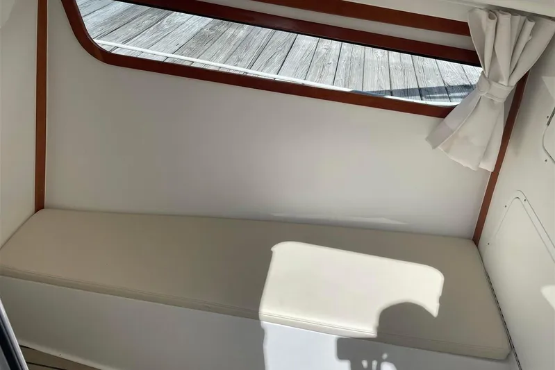 O-m-g Yacht Photos Pics Interior of 2023 MJM 3 boat with cushioned seating and window view.