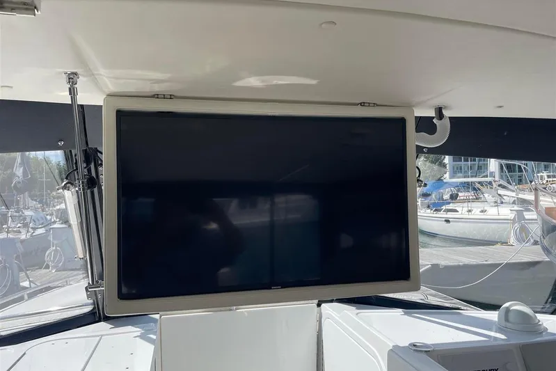 O-m-g Yacht Photos Pics 2023 MJM 3 boat interior with mounted screen, docked at marina.