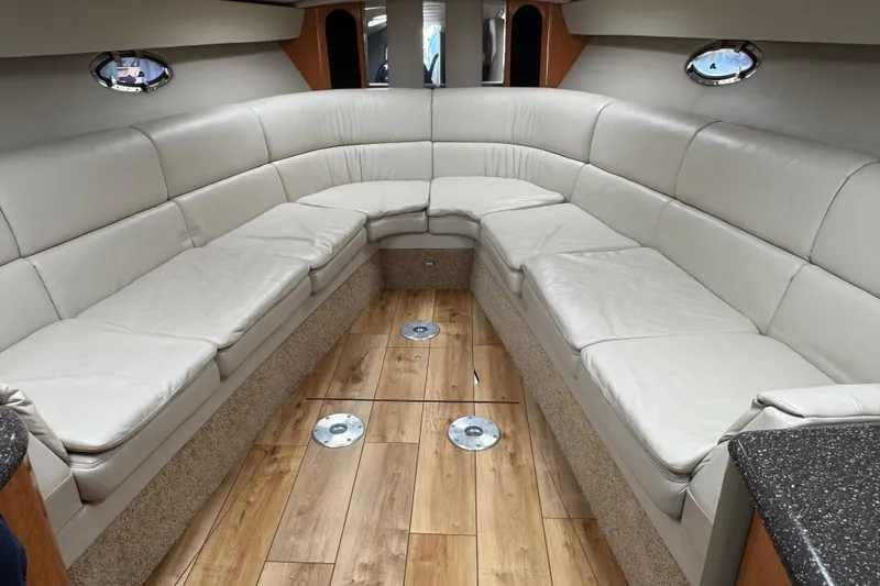  Yacht Photos Pics 2006 Formula 400 Super Sport interior with white leather seating and wood flooring.