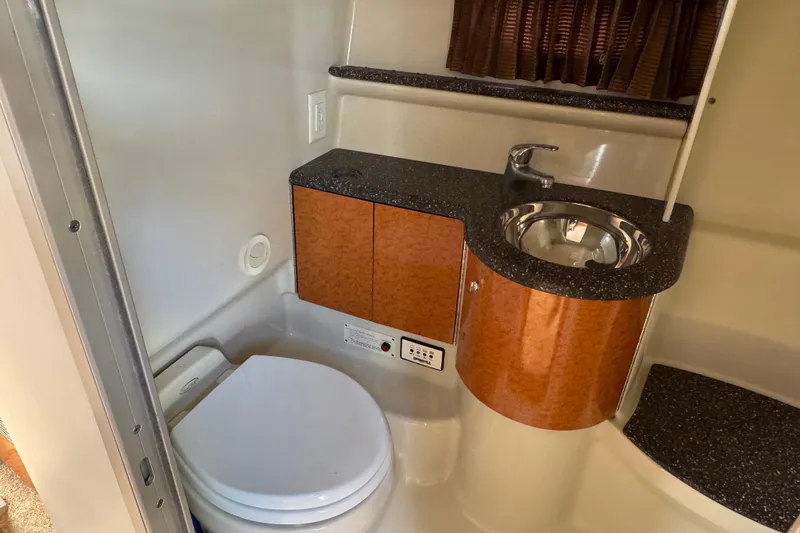  Yacht Photos Pics 2006 Formula 400 Super Sport bathroom with sink and toilet, featuring wood accents and modern design.