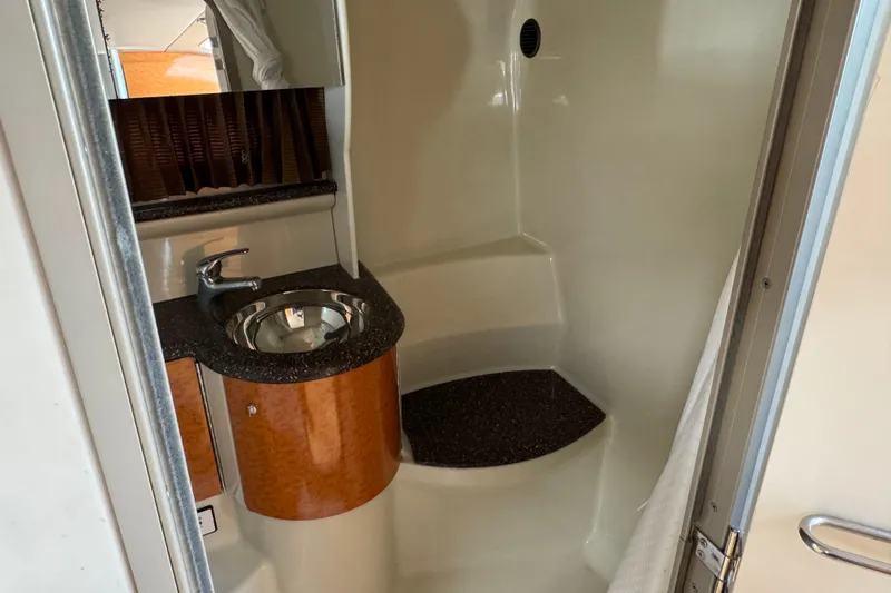  Yacht Photos Pics 2006 Formula 400 Super Sport bathroom with sink and mirror, featuring wood accents.