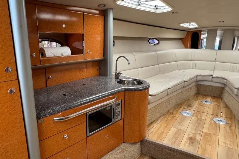  Yacht Photos Pics Luxurious interior of a 2006 Formula 400 Super Sport yacht with kitchenette and seating area.