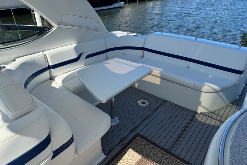  Yacht Photos Pics 2006 Formula 400 Super Sport boat interior with white seating and table, docked by water.