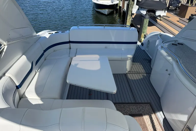  Yacht Photos Pics 2006 Formula 400 Super Sport boat interior with white seating and table, docked by the water.