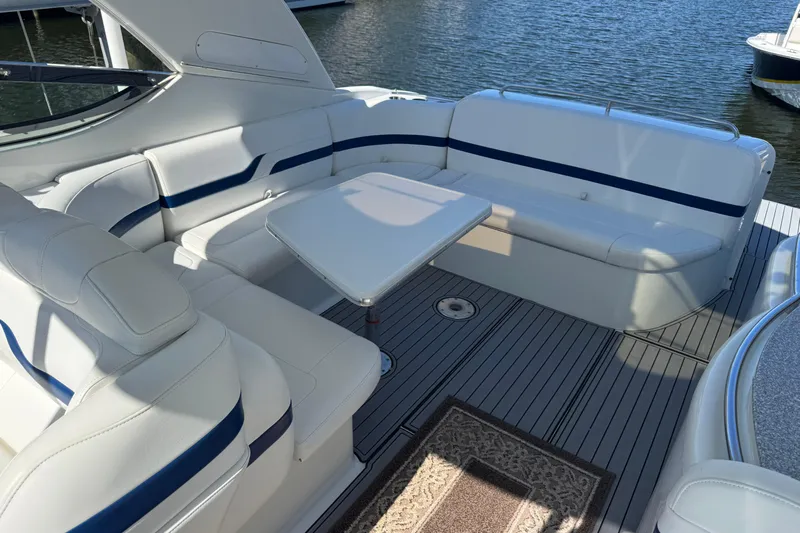  Yacht Photos Pics 2006 Formula 400 Super Sport yacht interior with white seating and table, docked by water.