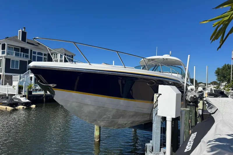  Yacht Photos Pics 2006 Formula 400 Super Sport boat docked near waterfront homes.