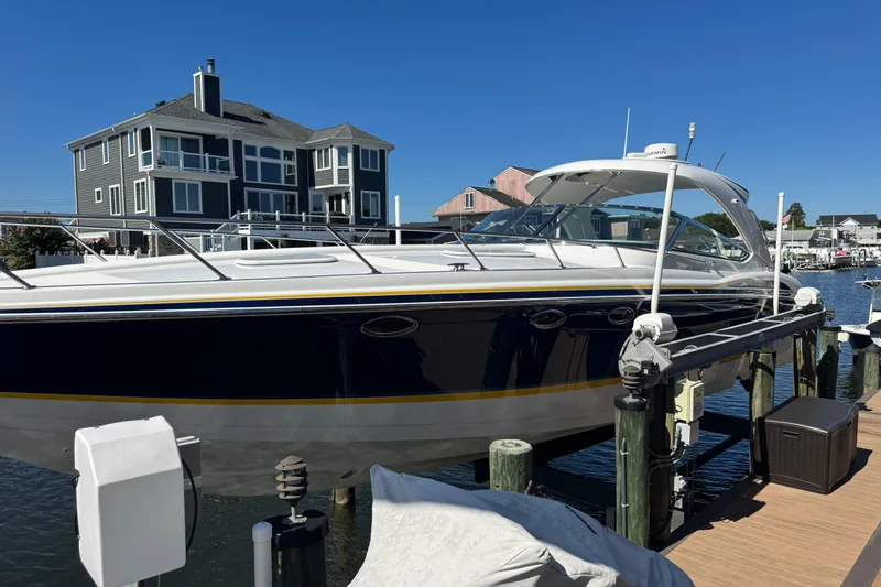  Yacht Photos Pics 2006 Formula 400 Super Sport boat docked near waterfront homes.