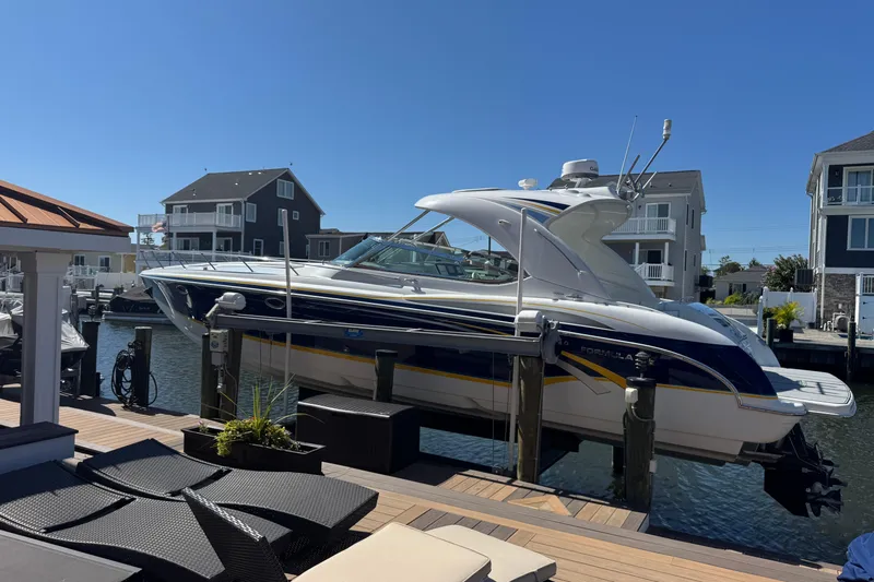  Yacht Photos Pics 2006 Formula 400 Super Sport boat docked in a residential marina setting.
