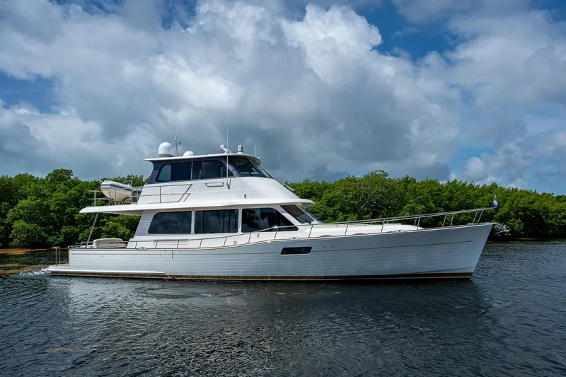 Painkiller Yacht Photos Pics 2023 Grand Banks GB60 yacht cruising on a scenic waterway.
