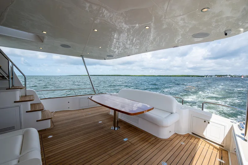 Painkiller Yacht Photos Pics Luxurious 2023 Grand Banks GB60 yacht deck with ocean view and elegant seating.