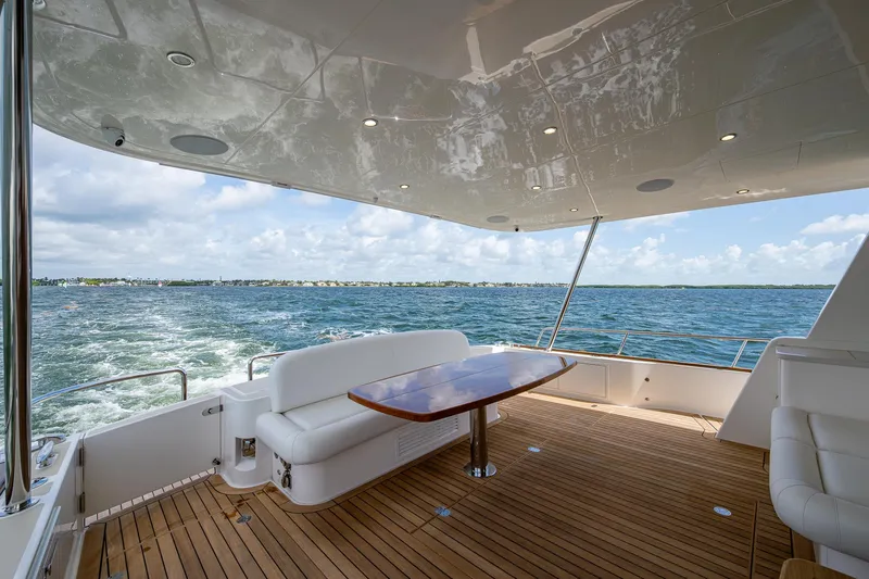 Painkiller Yacht Photos Pics Luxury 2023 Grand Banks GB60 yacht deck with ocean view and elegant seating.