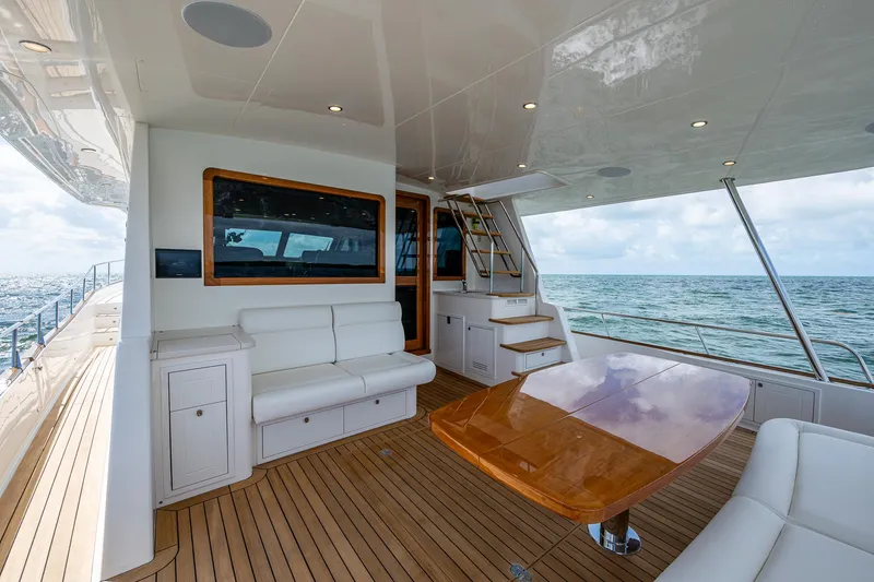 Painkiller Yacht Photos Pics Luxurious 2023 Grand Banks GB60 yacht deck with elegant seating and ocean view.