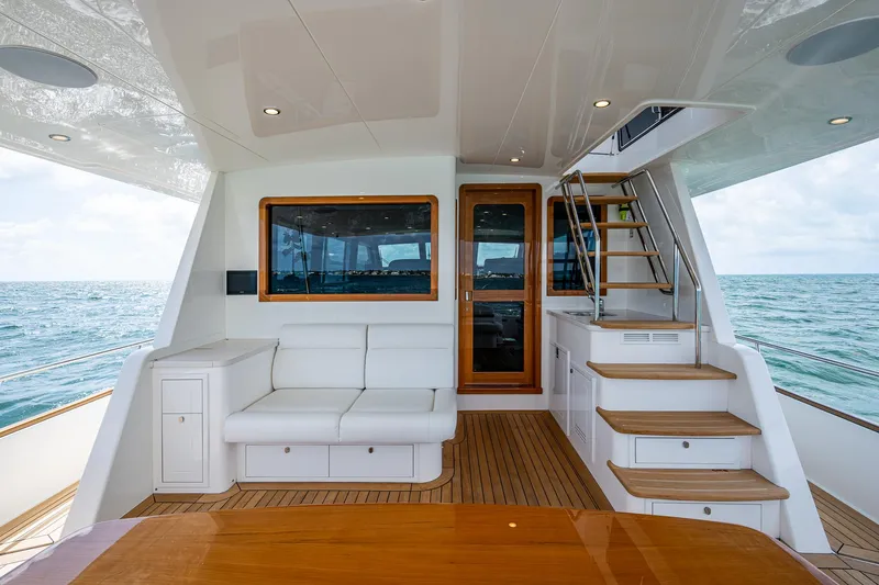Painkiller Yacht Photos Pics Luxurious 2023 Grand Banks GB60 yacht interior with elegant seating and ocean view.