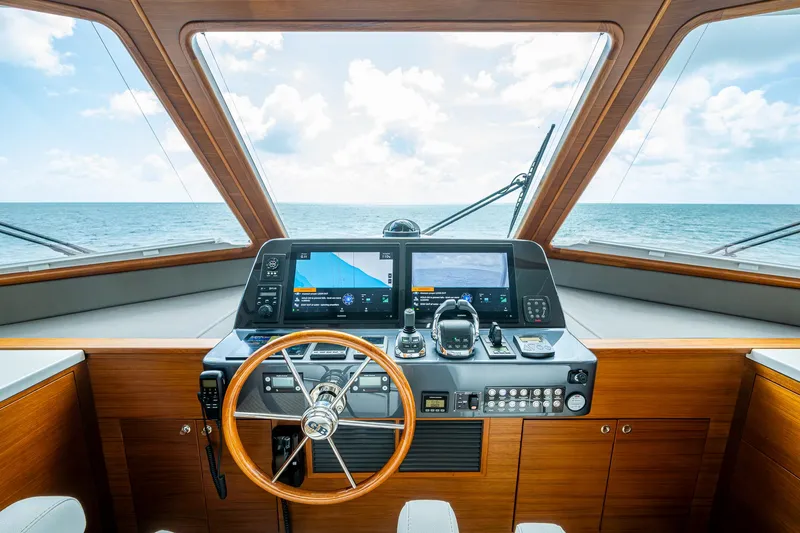 Painkiller Yacht Photos Pics 2023 Grand Banks GB60 helm with modern navigation equipment and ocean view.