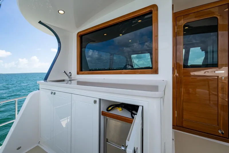 Painkiller Yacht Photos Pics 2023 Grand Banks GB60 yacht interior with sleek cabinetry and ocean view.