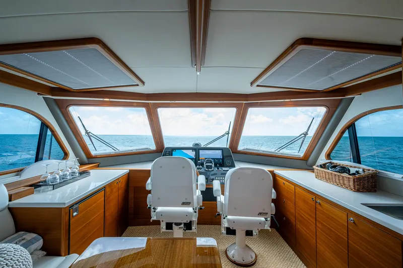 Painkiller Yacht Photos Pics Interior view of 2023 Grand Banks GB60 yacht helm with ocean view.