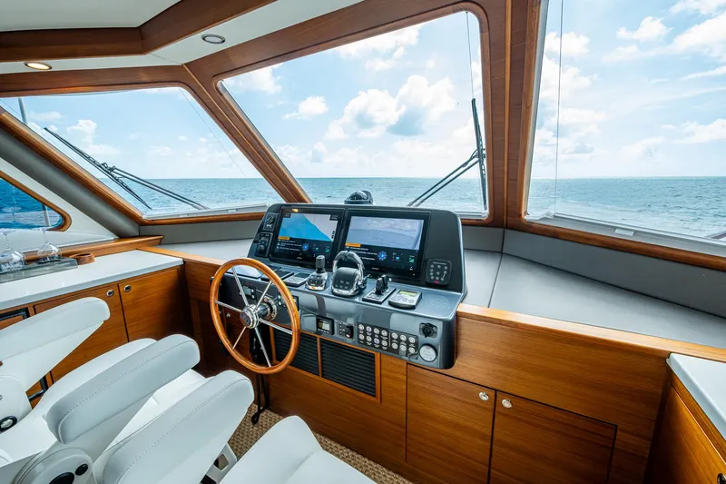 Painkiller Yacht Photos Pics Helm of 2023 Grand Banks GB60 yacht with ocean view and modern navigation equipment.
