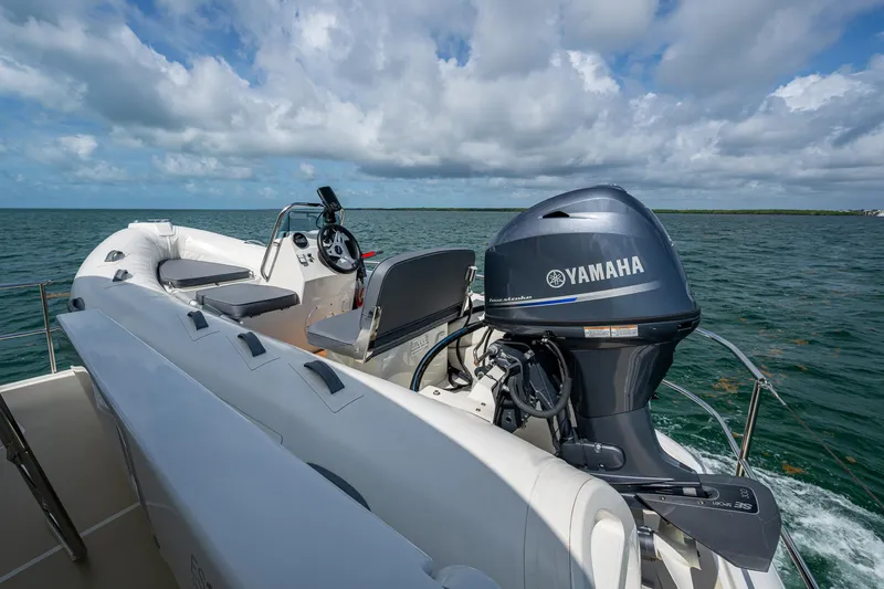 Painkiller Yacht Photos Pics 2023 Grand Banks GB60 boat with Yamaha engine on open water under cloudy sky.