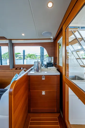 Painkiller Yacht Photos Pics Luxurious interior of 2023 Grand Banks GB60 yacht with wooden cabinetry and modern amenities.