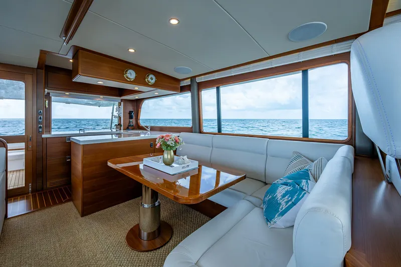 Painkiller Yacht Photos Pics Luxurious interior of 2023 Grand Banks GB60 yacht with ocean view and elegant seating area.