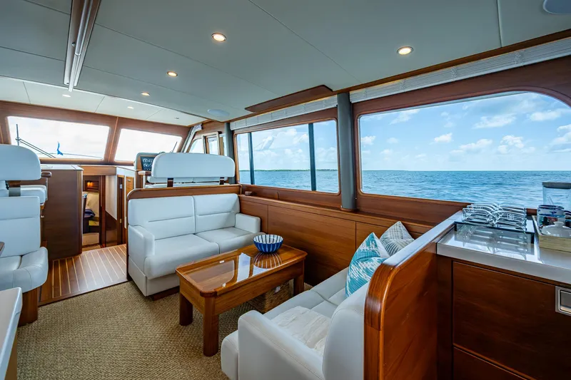 Painkiller Yacht Photos Pics Luxurious interior of 2023 Grand Banks GB60 yacht with ocean view and elegant furnishings.