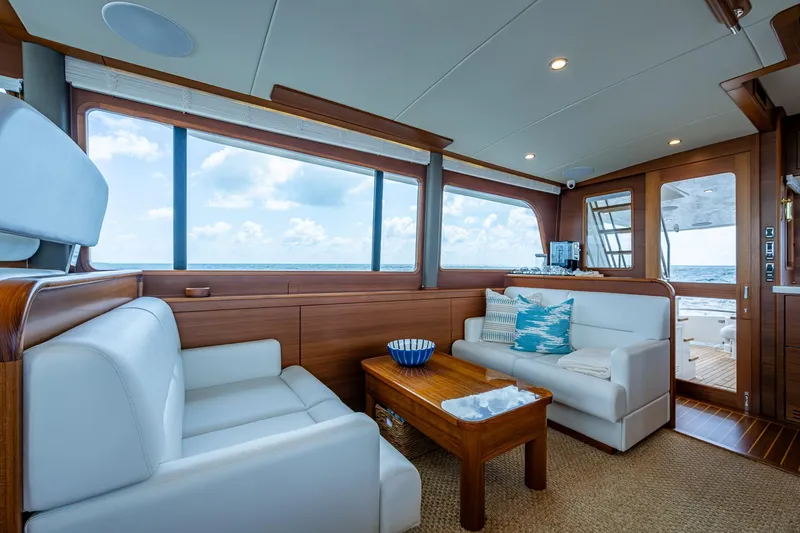 Painkiller Yacht Photos Pics Luxurious 2023 Grand Banks GB60 yacht interior with elegant seating and ocean view.