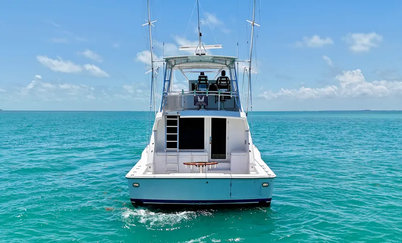 Yacht Photos Pics 2007 Bertram 570 yacht on clear blue ocean under sunny sky.