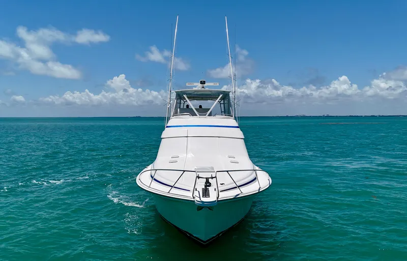  Yacht Photos Pics 2007 Bertram 570 yacht on turquoise ocean under clear blue sky.