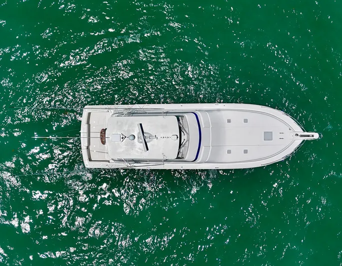  Yacht Photos Pics Aerial view of a 2007 Bertram 570 yacht on vibrant green water.