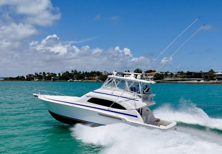  Yacht Photos Pics 2007 Bertram 570 yacht cruising on turquoise waters under a clear blue sky.