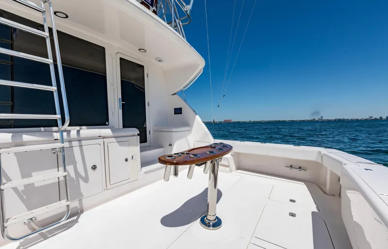  Yacht Photos Pics 2007 Bertram 570 yacht deck with ocean view, featuring a central table and ladder.
