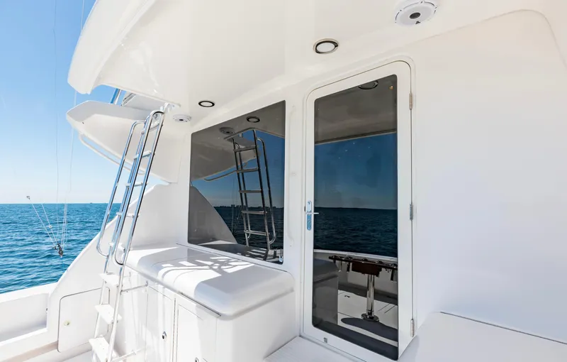  Yacht Photos Pics 2007 Bertram 570 yacht deck with ocean view and sleek white design.