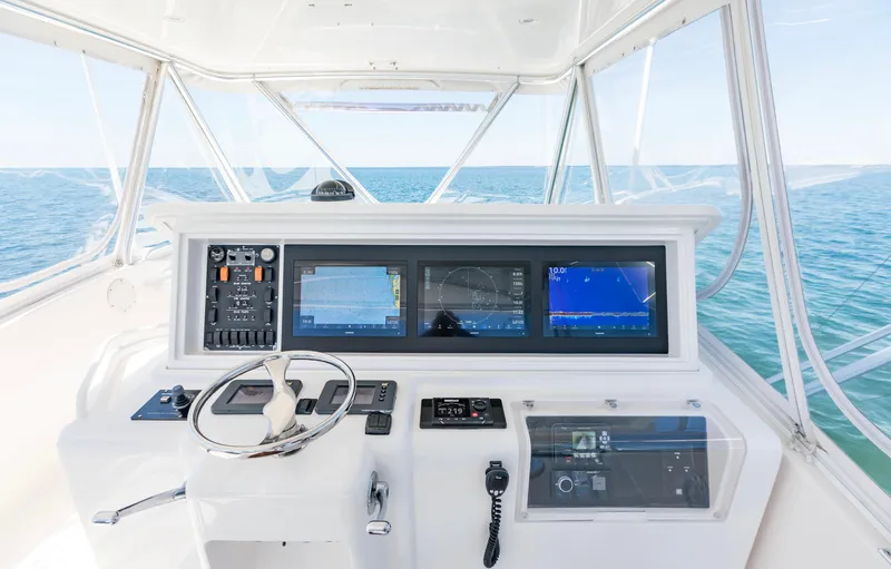  Yacht Photos Pics 2007 Bertram 570 yacht helm with advanced navigation systems, steering wheel, and ocean view.