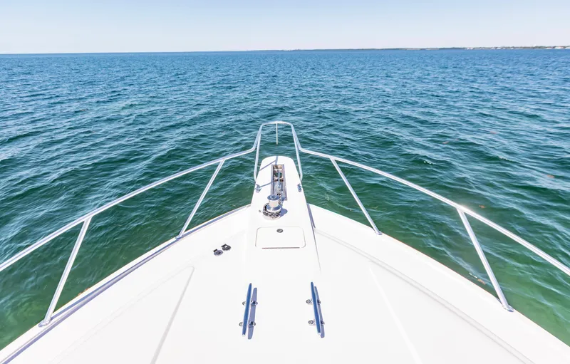  Yacht Photos Pics Bow view of 2007 Bertram 570 yacht cruising on open sea.