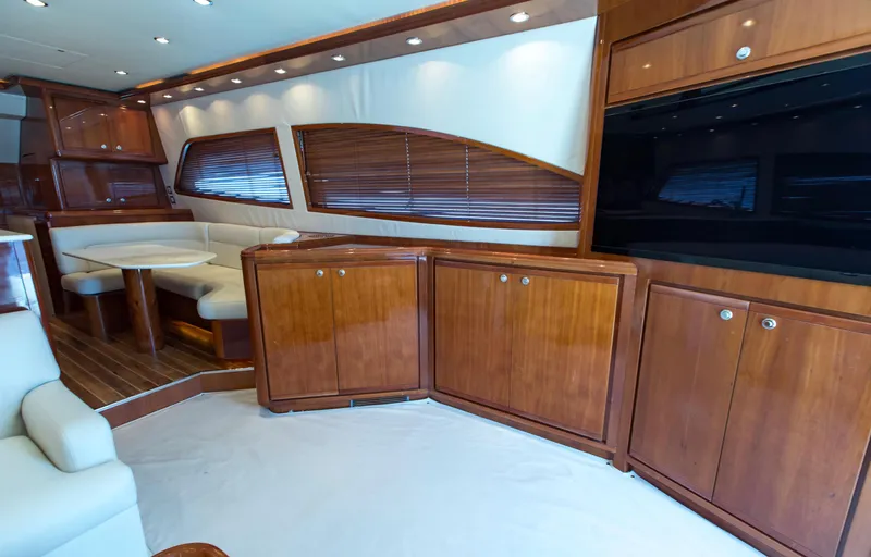  Yacht Photos Pics Luxurious interior of a 2007 Bertram 570 yacht with wooden cabinetry and seating area.