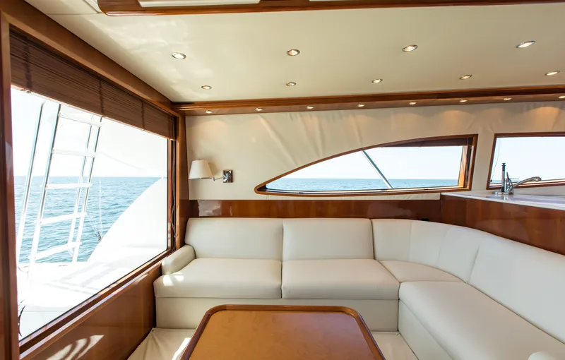  Yacht Photos Pics Luxurious interior of 2007 Bertram 570 yacht with ocean view and white seating.