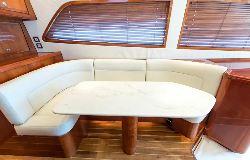  Yacht Photos Pics Luxurious interior of 2007 Bertram 570 yacht with elegant seating and wooden accents.