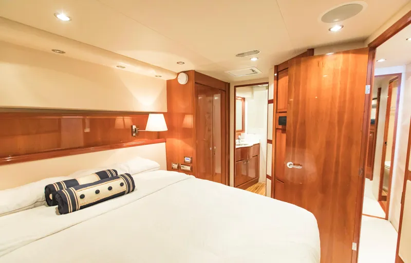  Yacht Photos Pics Luxurious cabin interior of a 2007 Bertram 570 yacht, featuring elegant wood finishes.