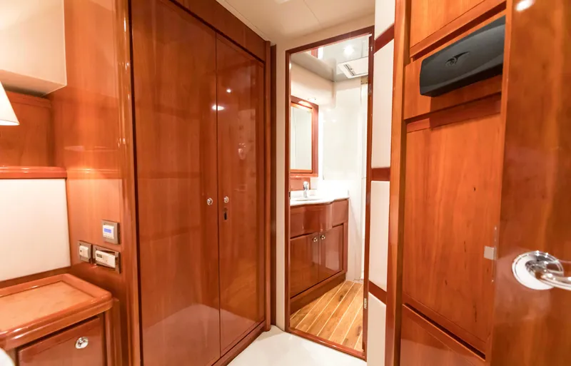  Yacht Photos Pics Luxurious wooden interior of 2007 Bertram 570 yacht, featuring a bathroom and storage area.