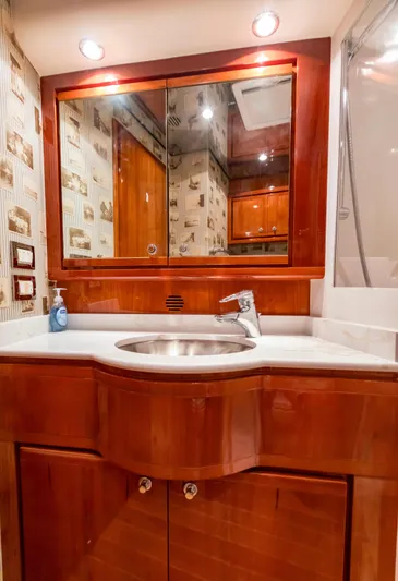  Yacht Photos Pics Luxurious bathroom in a 2007 Bertram 570 yacht with wooden cabinetry and modern fixtures.