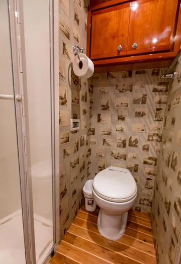  Yacht Photos Pics Luxury bathroom on 2007 Bertram 570 yacht with wood accents and patterned wallpaper.